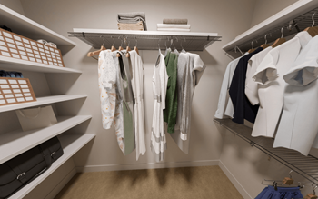A walk in closet with shelves and racks of clothes